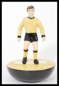 A Royal Doulton Subbuteo ceramic football figurine MCL 12 featuring a player in black and yellow kit