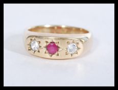 A hallmarked 9ct gold ring set with a central ruby