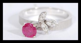 A 14ct white gold ruby and diamond ring having a c