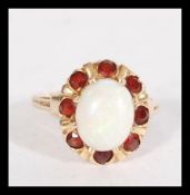 A 14ct gold opal and garnet cluster ring set with
