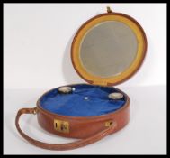 A vintage early 20th century round leather bag hav
