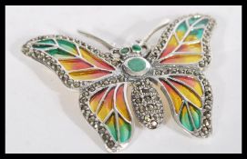 A silver and plique a jour brooch in the form of a