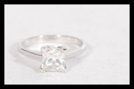 A hallmarked 9ct white gold ring having a square c