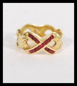A hallmarked 18ct gold and ruby band ring fashione