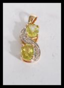 A hallmarked 9ct gold peridot and white stone set