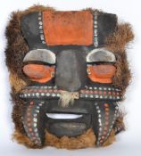 A vintage tribal  carved mask painted pigment and