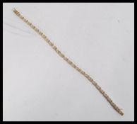 A hallmarked 9ct gold white stone set tennis brace