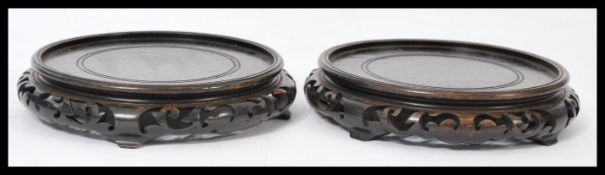 A pair of early 20th century large carved hardwood