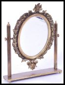 A 19th century brass mirror raised on plinth base