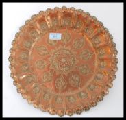 An early 20th century copper charger having a scal