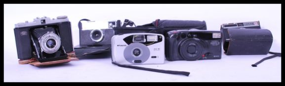 A vintage mid 20th Century Karl Zeiss Ikon Novar bellows folding camera in leather case together