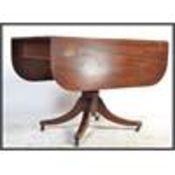 A Regency period solid mahogany drop leaf dining t