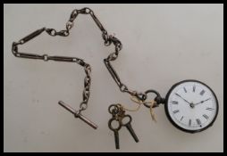A 19th century Victorian silver pocket watch with an Albert chain attached and two winding keys. The