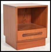 A retro 20th Century teak wood bedside cabinet by G - Plan, single drawer above open recess raised