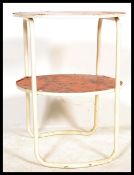 A retro 20th Century two tier tubular occasional table, the circular tops covered in a psychedelic