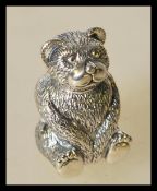 A vantage 20th century silver pin cushion in the form of a teddy bear with a red cushion to its