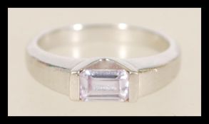 A hallmarked white gold ring with an inlaid flush stone item weighs 2.8 grams, size M.