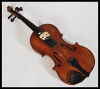 A vintage 20th century violin musical instrument having shaped hollow body with ebonised tuning