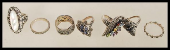 A collection of 20th century silver rings to include a 925 silver ring with purple rhinestones, a