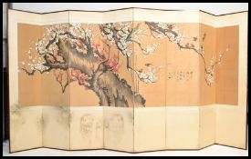 A vintage early 20th Century Japanese eight fold room divider, hand painted panel running throughout