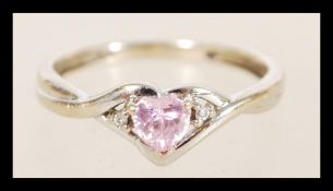 A white gold ring with a twisted split shank with pink heart form stones, item weight 1.4 grams,