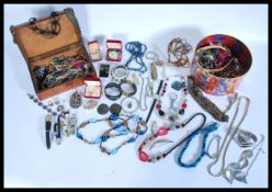 A collection of vintage costume and dress jewellery to include necklaces brooches etc. held within a