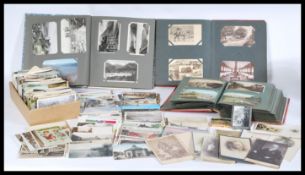 A collection of postcards dating from the early 20th century to include topographical, humor, artist