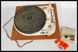 A Garrard 4HF vintage four speed record player, with auto stop, with its original rubber platter, on