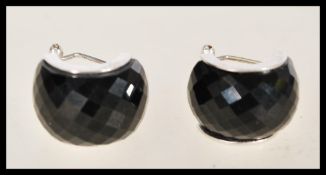 A pair of vintage 20th century silver hoop earrings with black cut onyx stones.