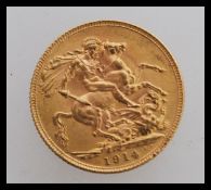 A 1914 London Mint gold sovereign featuring a portrait of George V facing left and a George dragon