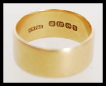A hallmarked 18ct gold band ring of large form. Weighs 10 grams.