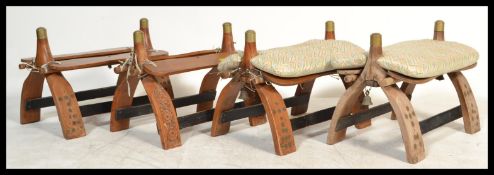 A collection of 5 vintage 20th century hardwood and brass adorned camel stools of varying shapes and