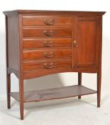 An Edwardian mahogany music cabinet with five short drawers to one side and a cupboard to the
