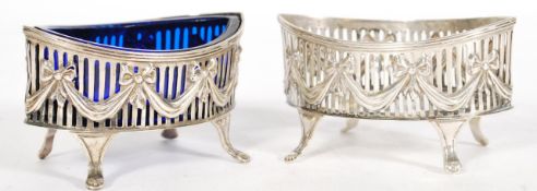 A pair of 19th century silver hallmarked table salts of elliptical form raised on pad feet with