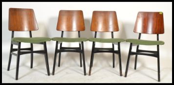 A group of four vintage retro 20th century teak dining chairs having green upholstery seats with