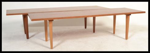 A pair of retro 20th Century circa 1960's teak wood coffee tables both raised on tapering supports.