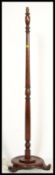 A vintage early 20th Century mahogany standard lamp and shade, on turned column upright supported by
