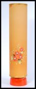 A vintage retro 1970's table lamp with a tall orange cylindrical shade having hand painted floral