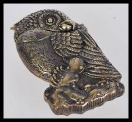 A vintage 20th century vesta case in the form of a parrot with a hinged head.
