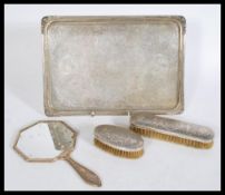 A Persian Islamic silver white metal vanity dresser set to include a a pair of brushes with floral