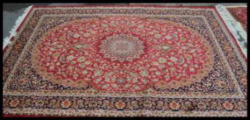 A large  vintage Persian floor carpet Keshan rug having a red ground with geometric borders and