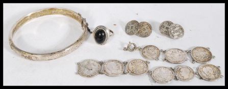 A group of vintage silver jewellery to include a hallmarked bangle, coin bracelet, ring etc.