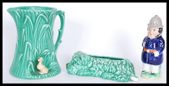 A 19th century late Victorian Staffordshire policeman pepper pot on a circular base with a blue