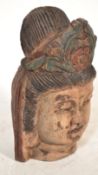 A 20th Century large carved wooden bust / head modelled as an Asiatic Buddha / Deity, retaining