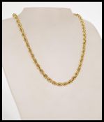 A hallmarked 9ct gold rope chain necklace with a round spring clasp. The necklace is approximately