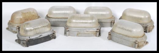 A set of seven vintage retro 20th century industrial prismatic bulkhead lights with brushed metal