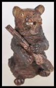 A vintage 20th century Austrian novelty cold painted metal figure of a bear smoking a cigarette in