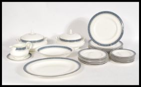 A 20th century vintage Royal Doulton Sherbrooke fine bone china dinner service with blue floral