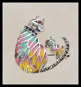 A vintage 20th century plique a jour brooch in the form of a cat and kitten with a hinge pin to