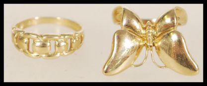 A pair of contemporary 9ct Birmingham hallmarked gold rings including a butterfly motif on a band
